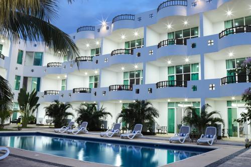 an exterior view of a hotel with a swimming pool at Costa Madero Resort in Los Ayala