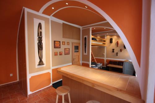 an archway in a kitchen with an orange wall at Pension Wunsch in Jaroměř