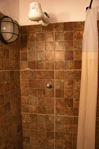 a bathroom with a shower with a shower curtain at Espaço João Mineiro in Tiradentes