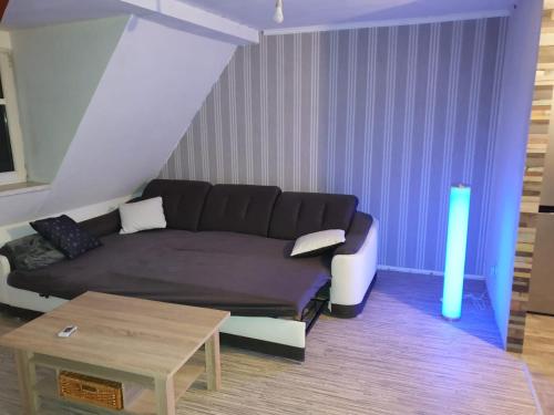 a living room with a couch and a table at Gemütliche Dachwohnung mit kleiner oder großer Dachterrasse nebeneinander in Wolmirstedt