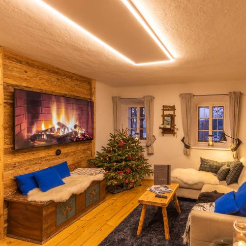 a living room with a fireplace and a christmas tree at Nestelberg 17 in Lackenhof