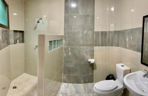 a bathroom with a toilet and a sink at Playa Arena in Progreso