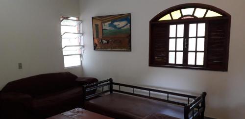 a living room with a couch and a window at Casa da cachoeira na beira do Rio Sana in Sana