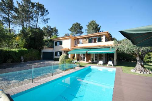 a villa with a swimming pool and a house at Casa de Marinhas Country House in Caminha