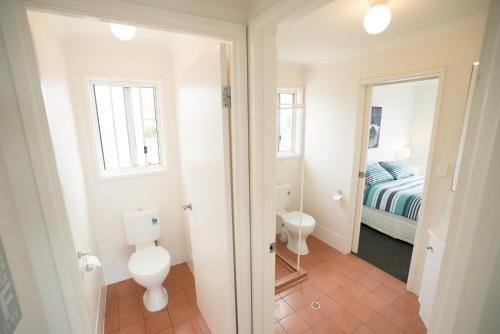 a bathroom with a toilet and a bed in a room at SeaWatch-Sea Views in Middleton