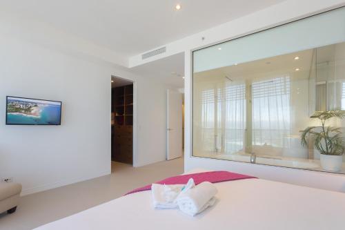 a bedroom with a large window and a bed at Oracle Resort Broadbeach - gclr in Gold Coast