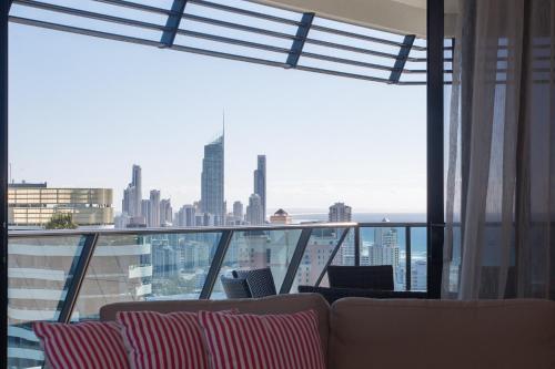 a living room with a view of a city at Oracle Resort Broadbeach - gclr in Gold Coast