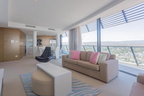 a living room with a couch and a table at Oracle Resort Broadbeach - gclr in Gold Coast