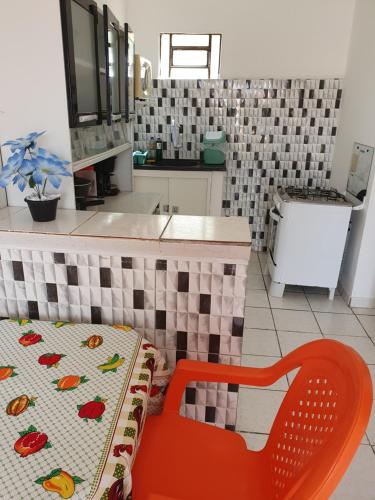 a kitchen with a red chair and a sink at Flatstom in Parnaíba
