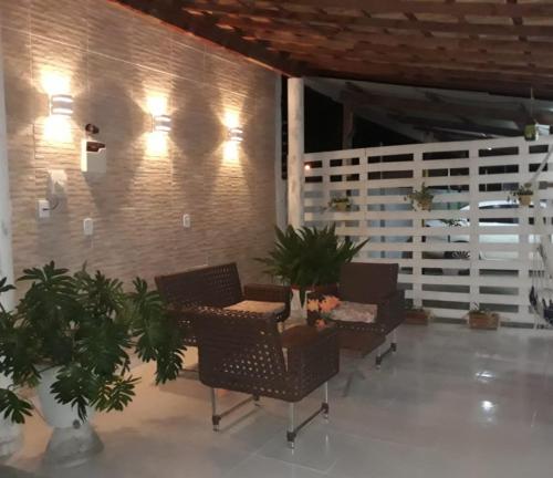 a lobby with chairs and a wall with plants at Flatstom in Parnaíba