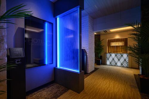 a hallway with a blue light in a building at ホテル ゼン横浜町田 in Yokohama