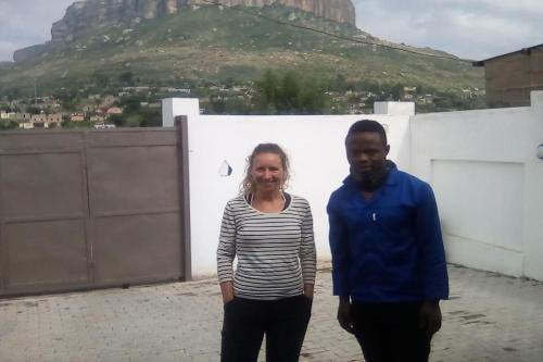 a man and a woman standing on top of a building at Maluti Backpackers in Phuthaditjhaba