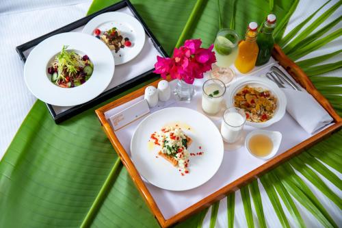 a table with plates of food on a tray at Pullman Resort Xishuangbanna in Jinghong