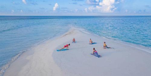 a group of people on a beach in the ocean at Sea View Villa Ukulhas in Ukulhas
