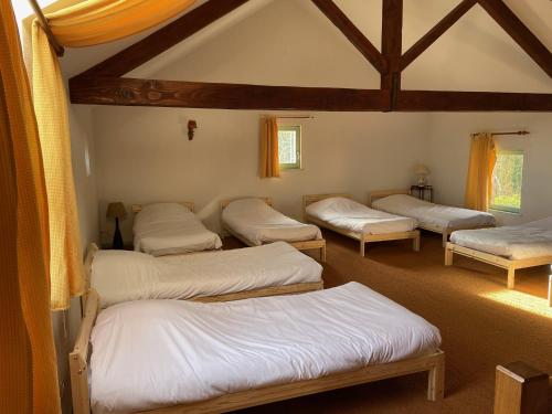 a room with four beds in a room at Du côté de chez Sam in Andelaroche