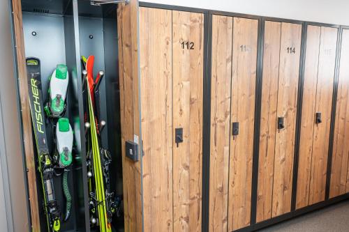 a row of wooden panels with skis and snowboards at Hotel Zehnerkar & Hotel Obertauern in Obertauern