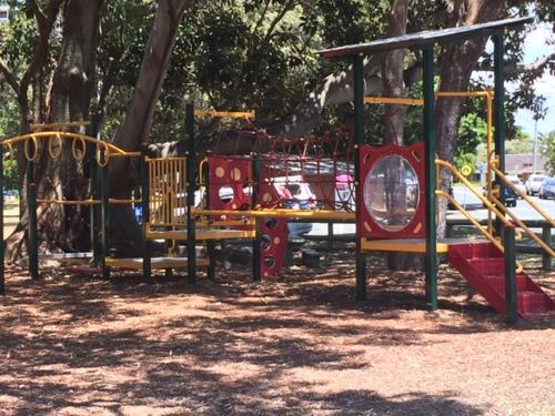 a playground in a park with a slide at Just Perfect Apartment with Ocean Views in Caloundra