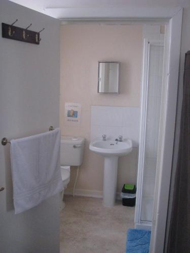 a bathroom with a white sink and a toilet at MyRoomz New Discovery Hotel in Blackpool