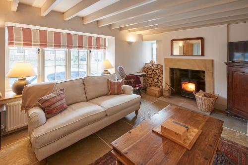 a living room with a couch and a fireplace at Host & Stay - The Cobbles in Osmotherley