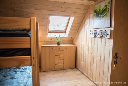 a small room with a bunk bed and a window at Grenzhaus in Karlstift