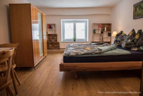 a bedroom with a large bed and a window at Grenzhaus in Karlstift