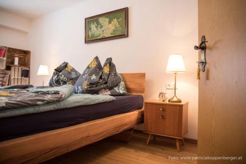 a bedroom with a bed with pillows on it at Grenzhaus in Karlstift
