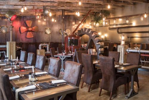 a restaurant with tables and chairs in a room at Alte Brucke Holiday Resort in Swakopmund