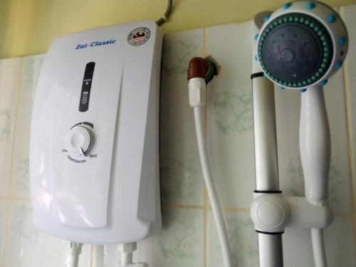a hair dryer and a blow dryer next to a shower at Sunset Paradise Holidays Homes in Shanzu