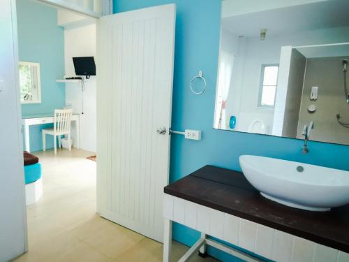 a bathroom with a white sink and a mirror at Glur Hostel in Ao Nang Beach