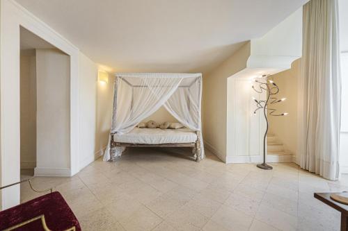 a room with a bed with a mosquito net at Casa Bormioli - Maison de Charme in Procida