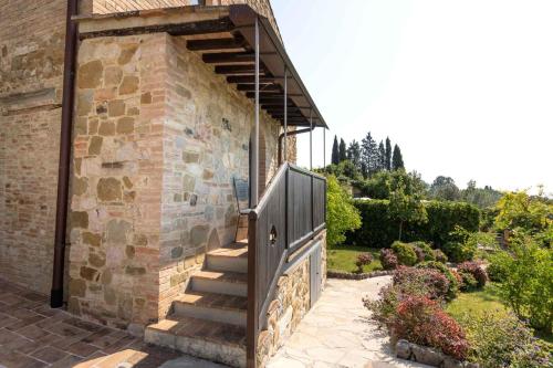 a stone building with a wooden gate and stairs at Castello Di Monterone in Perugia