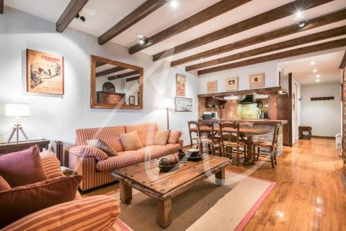 a living room with a couch and a table at Amitges by SeaMount Rentals in Baqueira-Beret