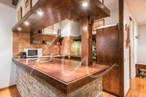 a kitchen with a large wooden counter top at Amitges by SeaMount Rentals in Baqueira-Beret
