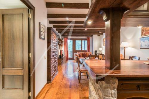a living room with a table and a dining room at Amitges by SeaMount Rentals in Baqueira-Beret