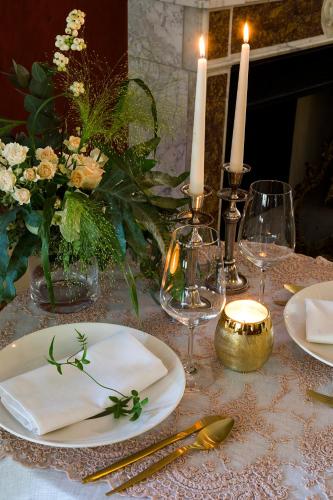 a table with plates and candles and flowers on it at Abano Grand Hotel in Abano Terme