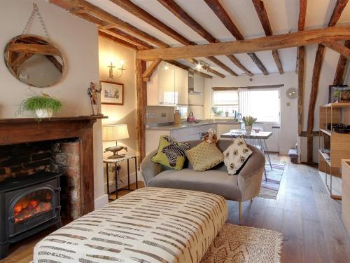 a living room with a couch and a fireplace at Cartref in Farnham