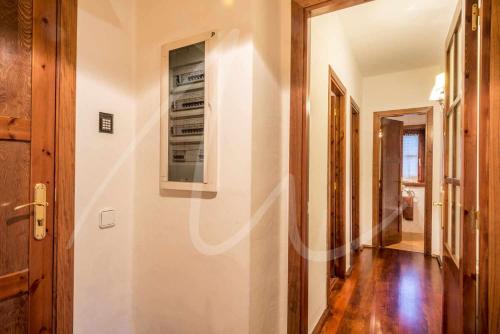 a hallway of a house with a door and a hallway at Nin de Beret by SeaMount Rentals in Baqueira-Beret