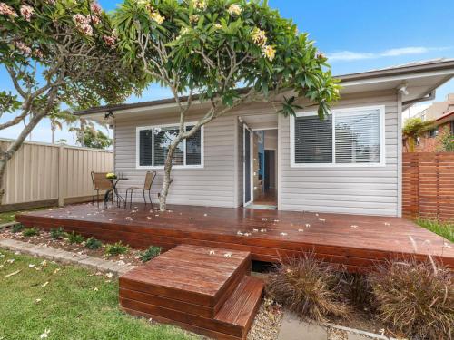 a wooden deck in front of a house at Sandy Toes in Forster