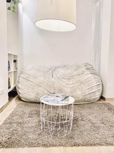 a white living room with a couch and a table at The Luxury Loft Vienna in Vienna