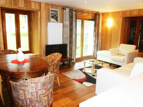 a living room with a table and chairs at Aiguille du Midi - Hôtel & Restaurant in Chamonix-Mont-Blanc