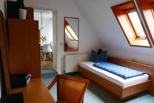 a small room with a bed and a mirror at Ferienhaus Lütsche in Frankenhain
