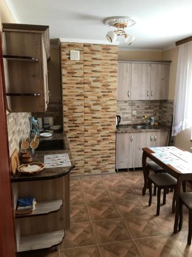 a kitchen with a table and a dining room at Домашня Оселя in Yaremche