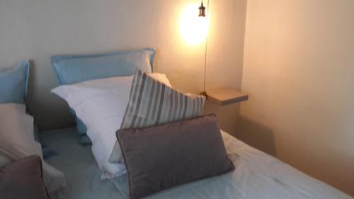 a bedroom with a bed with a pillow on it at Chambres d'hôtes Le Vignoble in Cucuron
