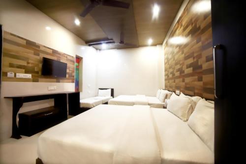 a bedroom with a bed and a couch and a tv at Hotel Star Light in Amritsar