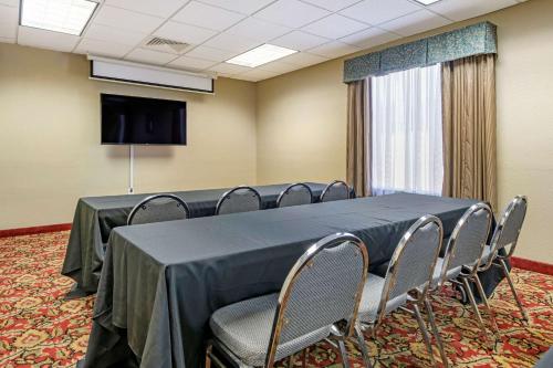 a conference room with a table and chairs and a tv at Quality Inn Zephyrhills-Dade City in Zephyrhills