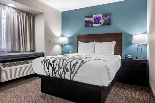 a hotel room with a large bed and a window at Sleep Inn St Robert-Fort Leonard Wood in Saint Robert