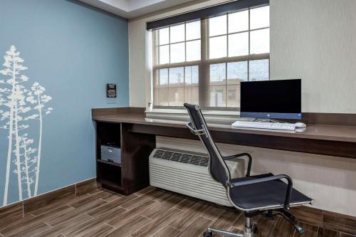 a office with a desk with a computer and a chair at Sleep Inn St Robert-Fort Leonard Wood in Saint Robert