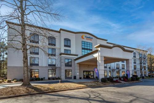 a hospital building with a tree in front of it at Comfort Suites Alpharetta-Roswell - Atlanta Area in Alpharetta