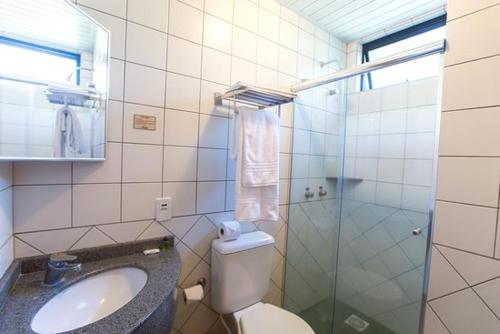 a bathroom with a toilet and a sink at Almasty Hotel in Chapecó