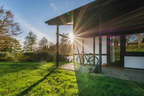 a house with the sun shining through the window at Sporthotel Grafenwald 4 Sterne Superior in Daun